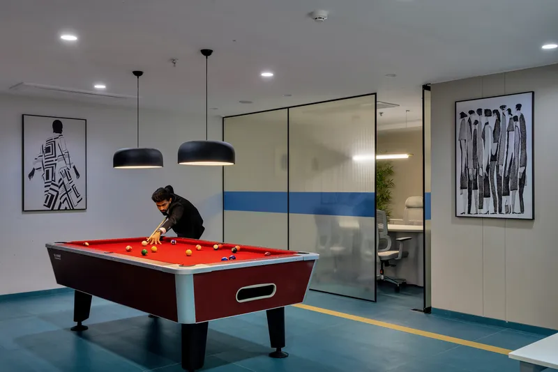 Conference room with curved natural stone walls and club-inspired textured wall paneling.